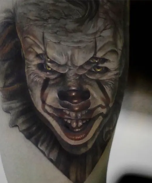 Clown tattoo with overlapping eyes.