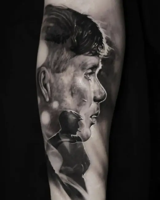 Black-and-grey realism tattoo of a male profile with a layered silhouette